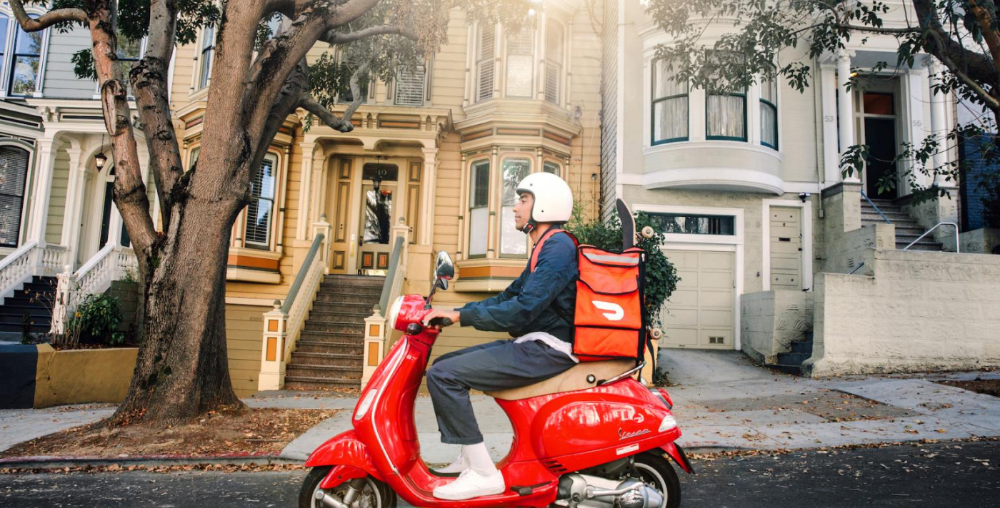 DoorDash "Dasher" delivering on his scooter in the city